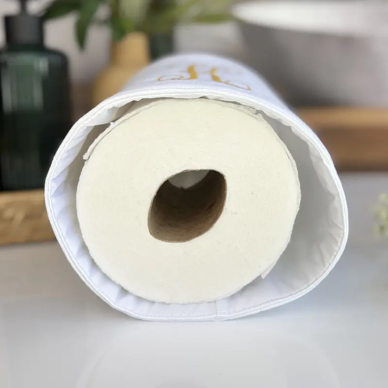 Handmade fabric toilet paper cover in farmhouse style bathroom with coordinating tissue box cover