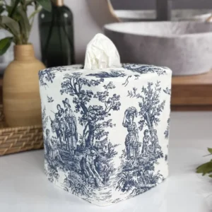Handmade navy toile tissue box cover with white florals and woven tray in styled bathroom
