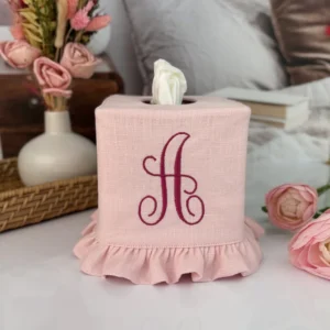 Pink monogram linen tissue box cover with dark pink script A monogram and ruffle trim on a vanity with roses
