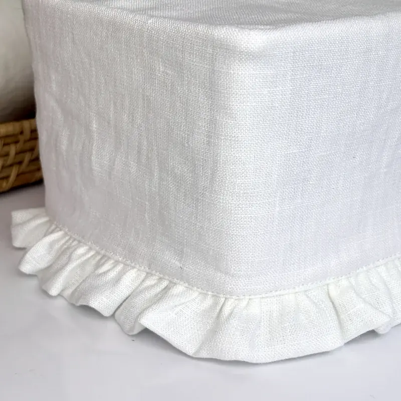 Close-up of white linen ruffle trim on rectangle tissue box cover showing woven texture