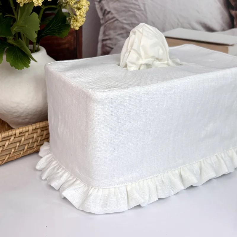 White linen ruffle rectangle tissue box cover side view showing fabric texture and ruffle hem