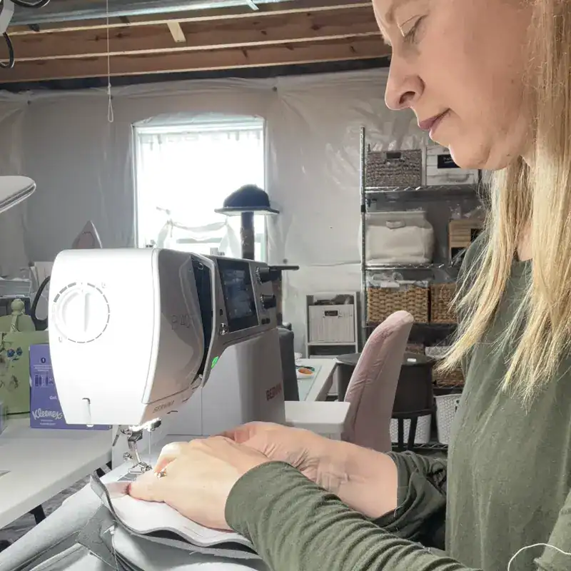 Woman sewing handmade linen tissue box cover on Bernina B 480 sewing machine in home studio