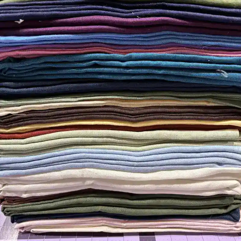 Stack of 20 plus premium linen fabric colors for handmade tissue box covers made in USA