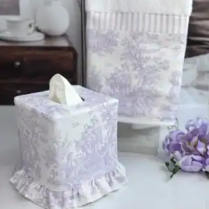 Lavender toile tissue box cover and towel set on a bright vanity