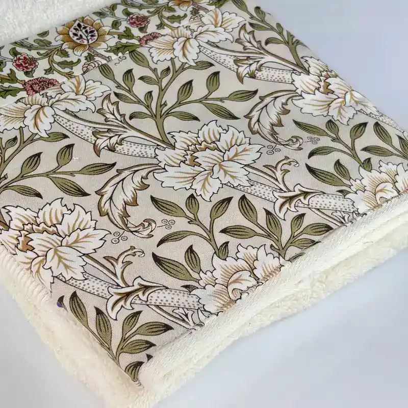 Folded vintage floral hand towel showing the green botanical print fabric up close, made in the USA