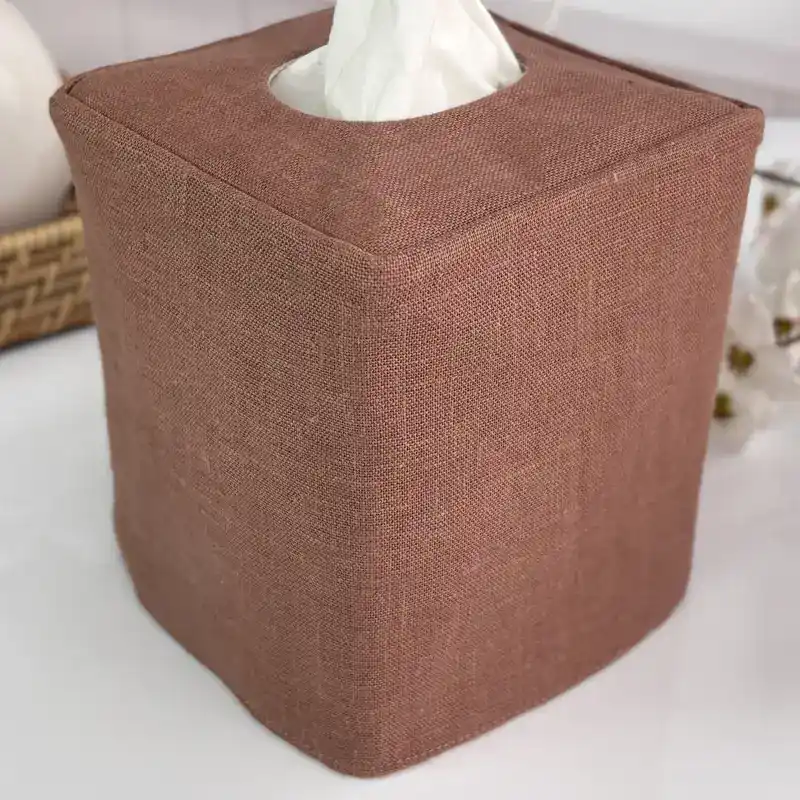 Close up of a handmade brown linen tissue box cover showing crisp corners and soft natural linen texture