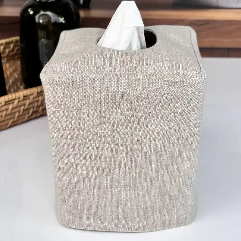 Front view of a handmade linen tissue box cover in natural flax color for a neutral farmhouse bathroom