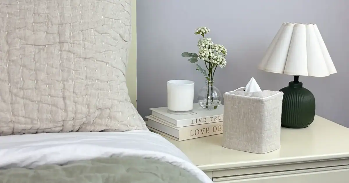 Natural linen piped tissue box cover in a calm bedroom with a natural linen quilt