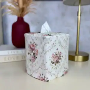 Rose floral tissue box cover front view next to a red vase with dried pampas grass