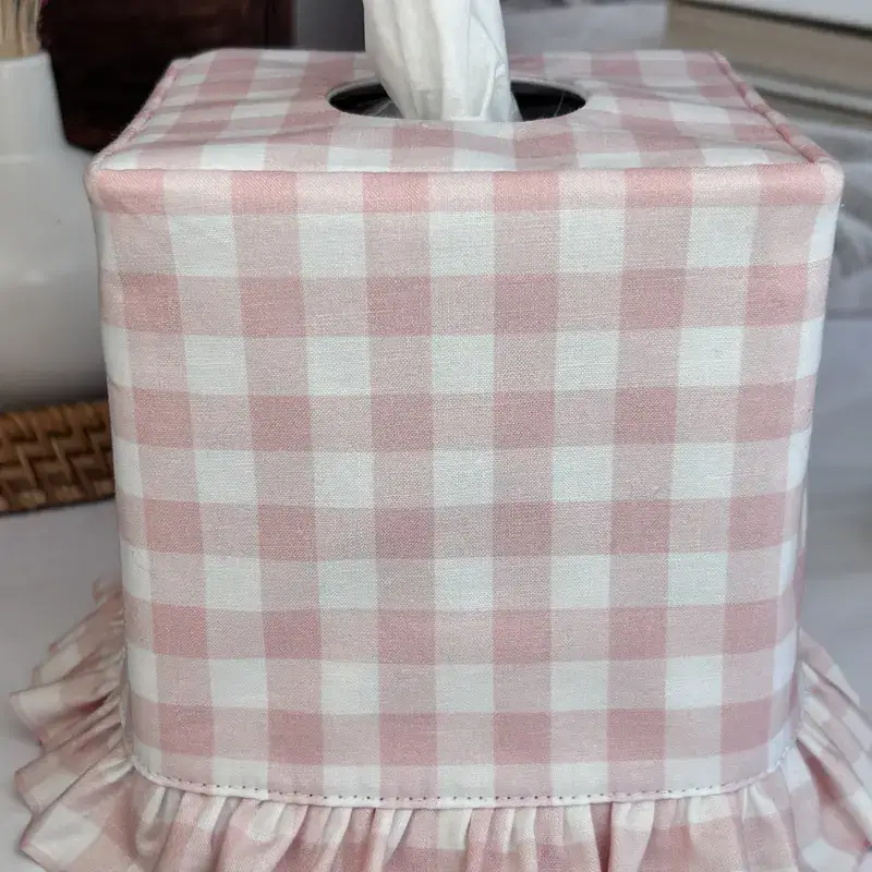 Close up of pink gingham check fabric on a handmade boutique tissue box cover with ruffle hem